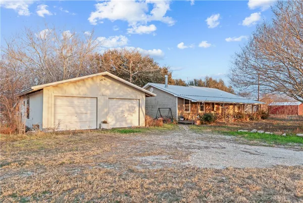 a big house with a big yard and large trees