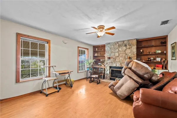 a living room with furniture a flat screen tv and a large window