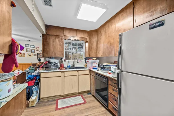a kitchen with a sink a stove and cabinets
