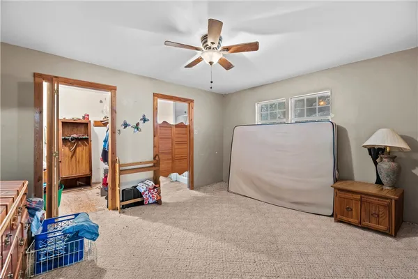 a living room with furniture and a ceiling fan