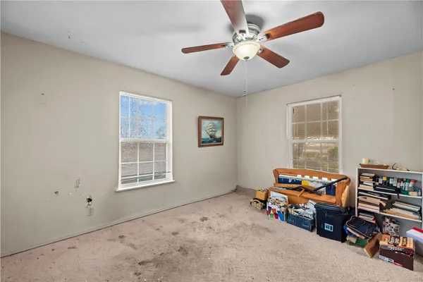 a bedroom with furniture and a window