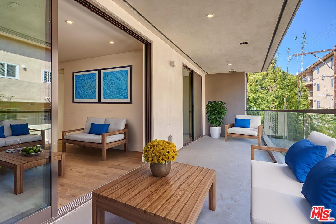 411 South Hamel Road, Unit 306 Los Angeles, CA 90048 - Photo 16 of 40 a living room with furniture and a potted plant