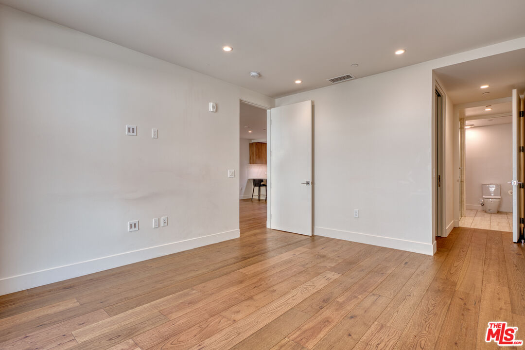 411 South Hamel Road, Unit 306 Los Angeles, CA 90048 - Photo 20 of 40 a view of an empty room with wooden floor