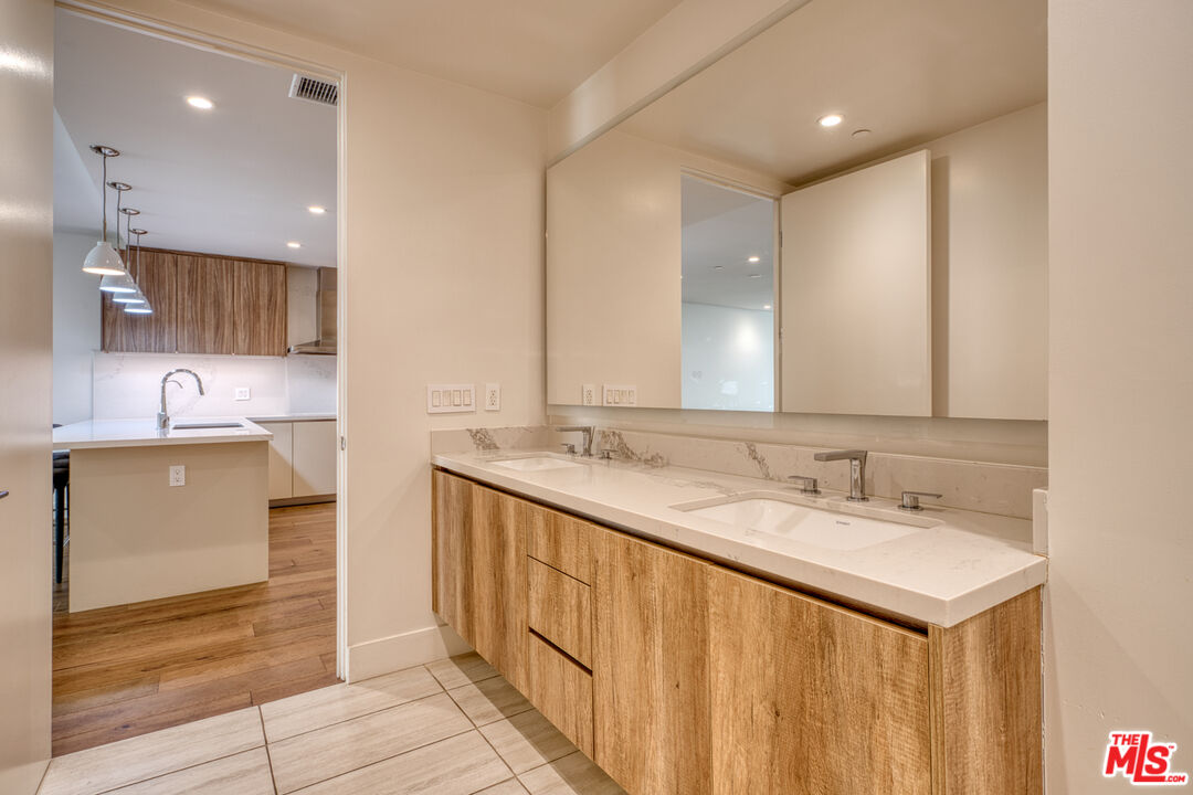 411 South Hamel Road, Unit 306 Los Angeles, CA 90048 - Photo 26 of 40 a bathroom with a double vanity sink and a mirror