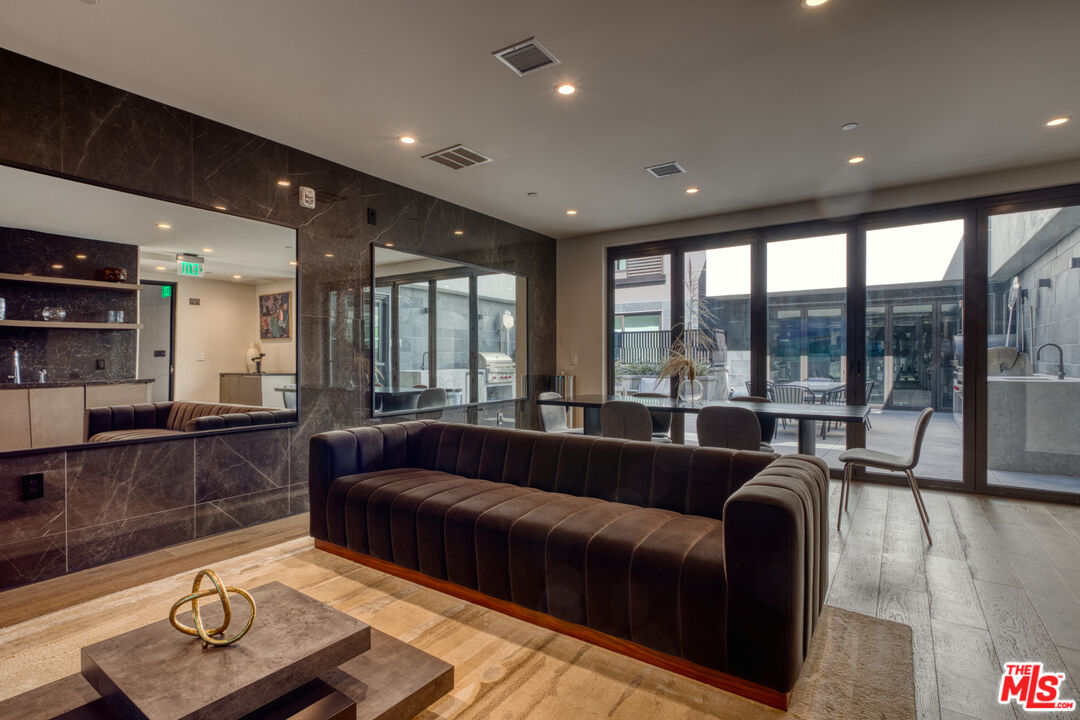 411 South Hamel Road, Unit 306 Los Angeles, CA 90048 - Photo 33 of 40 a living room with furniture and a large window