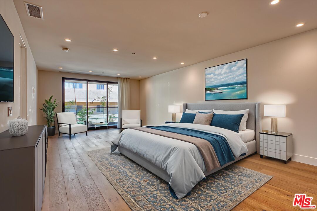 411 South Hamel Road, Unit 306 Los Angeles, CA 90048 - Photo 40 of 40 a spacious bedroom with a large bed and a couch