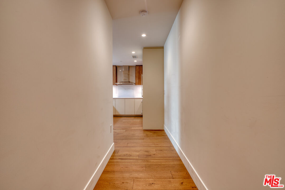 411 South Hamel Road, Unit 306 Los Angeles, CA 90048 - Photo 4 of 40 a view of a hallway with wooden floor