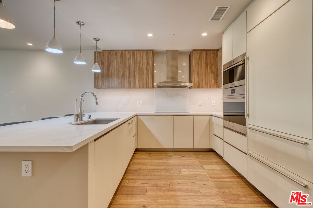 411 South Hamel Road, Unit 306 Los Angeles, CA 90048 - Photo 5 of 40 a kitchen with stainless steel appliances granite countertop a sink and oven