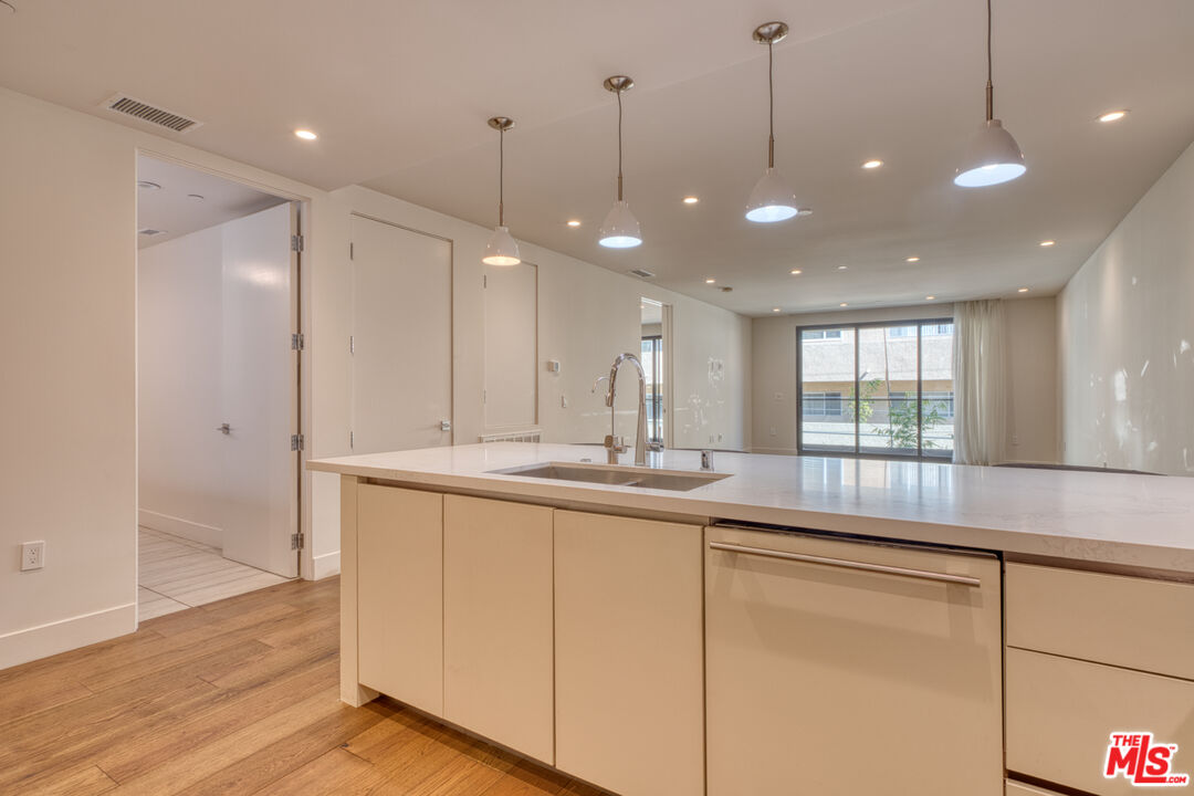 411 South Hamel Road, Unit 306 Los Angeles, CA 90048 - Photo 7 of 40 a kitchen with center island and windows