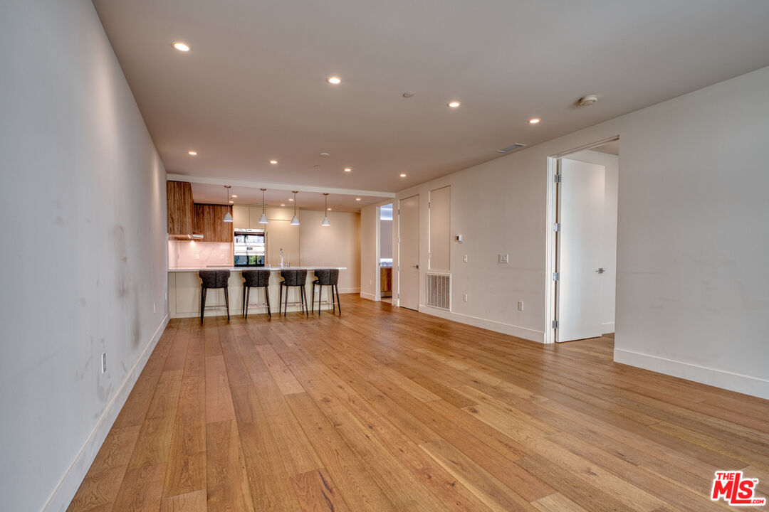 411 South Hamel Road, Unit 306 Los Angeles, CA 90048 - Photo 10 of 40 a view of an empty room with wooden floor