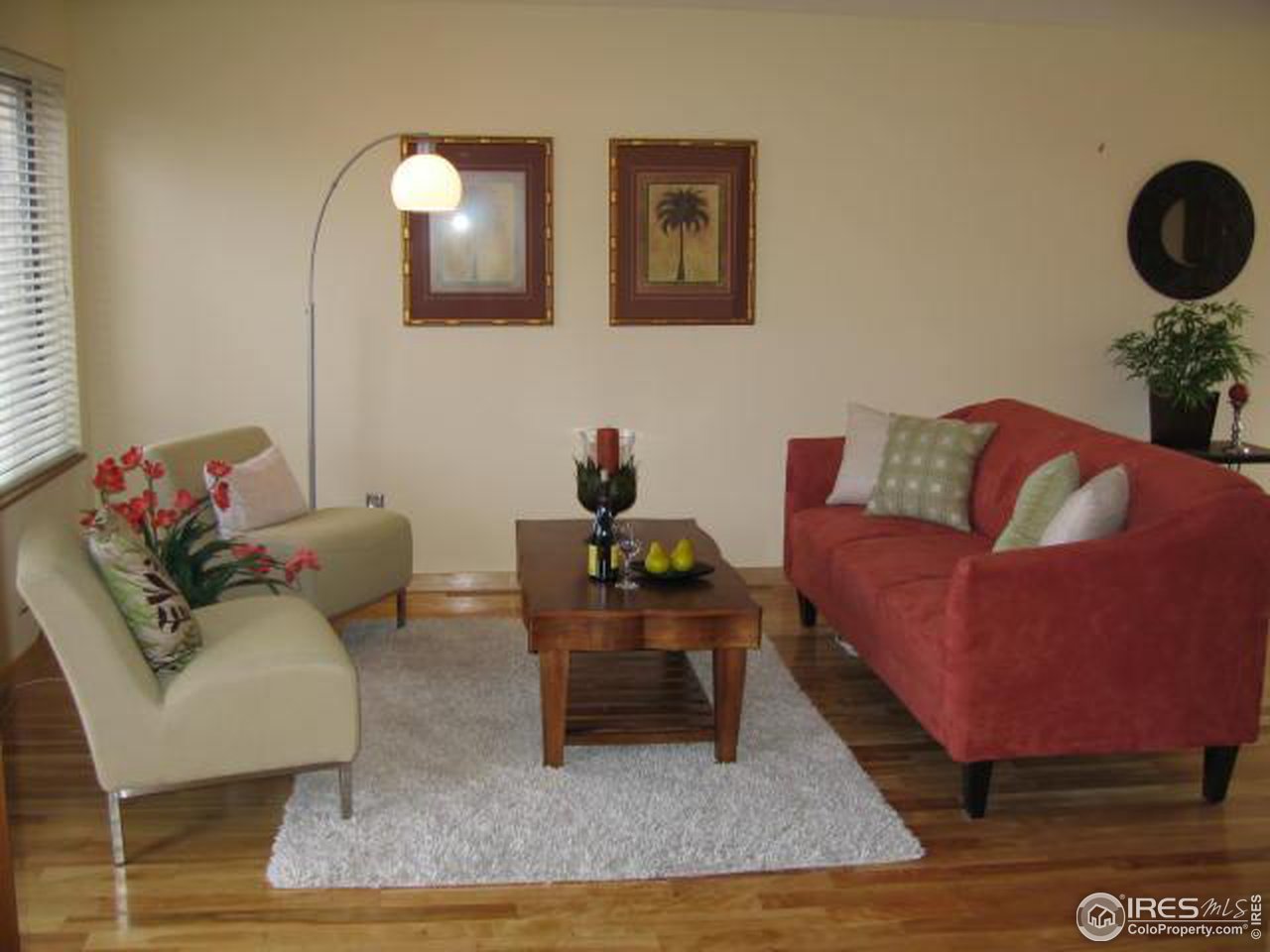 a living room with furniture and a mirror