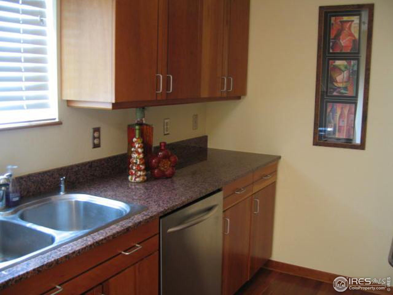 780 Walnut Street, Unit D Boulder, CO 80302 - Photo 3 of 14 a kitchen with a sink cabinets and wooden floor
