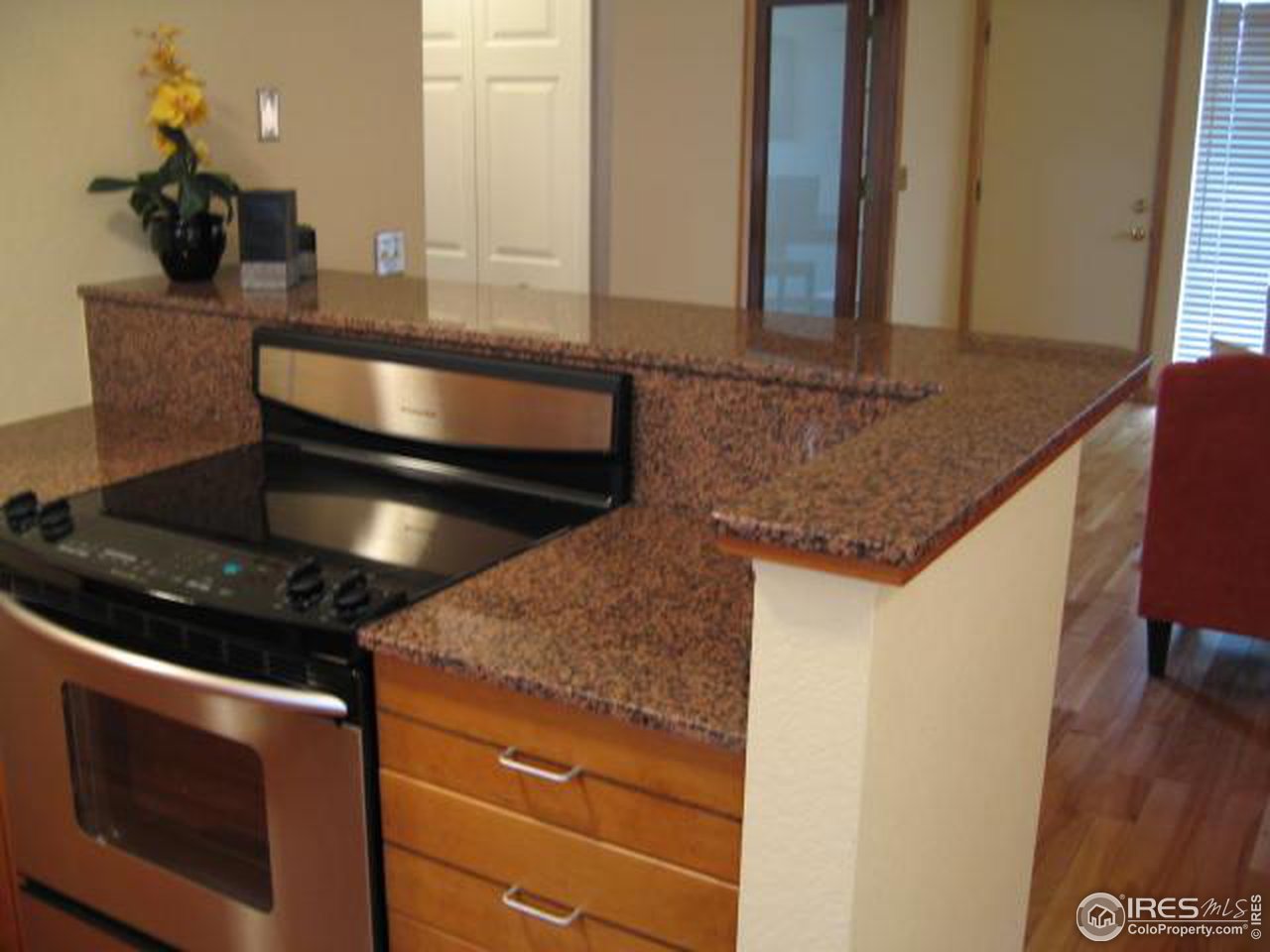 780 Walnut Street, Unit D Boulder, CO 80302 - Photo 4 of 14 a kitchen with a stove and a cabinet