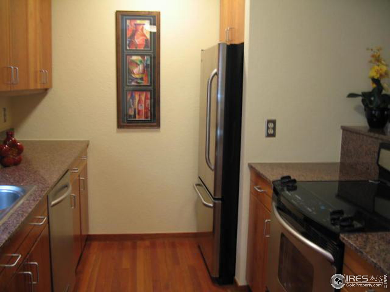 780 Walnut Street, Unit D Boulder, CO 80302 - Photo 5 of 14 a kitchen with a refrigerator and a stove top oven