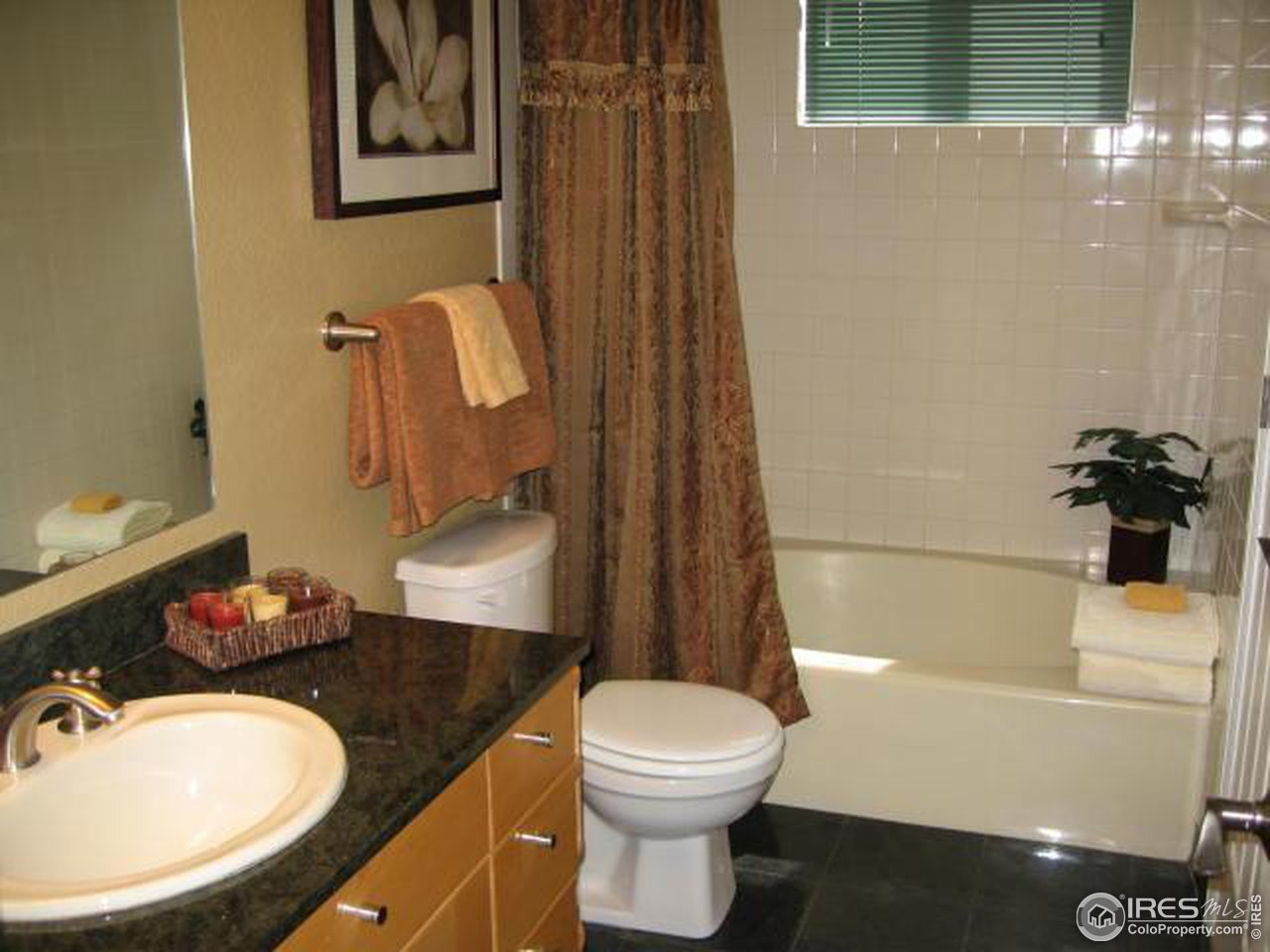 780 Walnut Street, Unit D Boulder, CO 80302 - Photo 7 of 14 a bathroom with a granite countertop sink mirror vanity and toilet