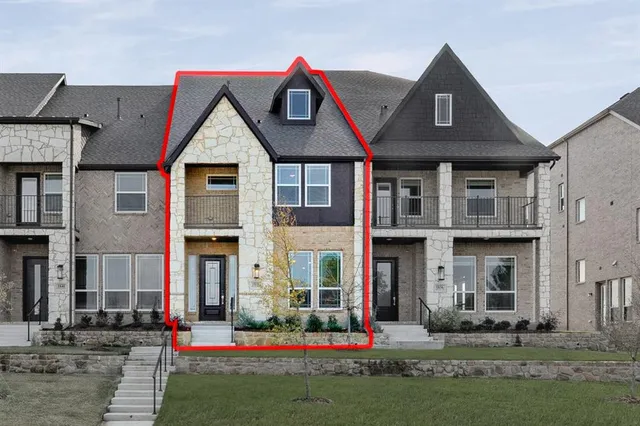 a front view of brick house with a yard