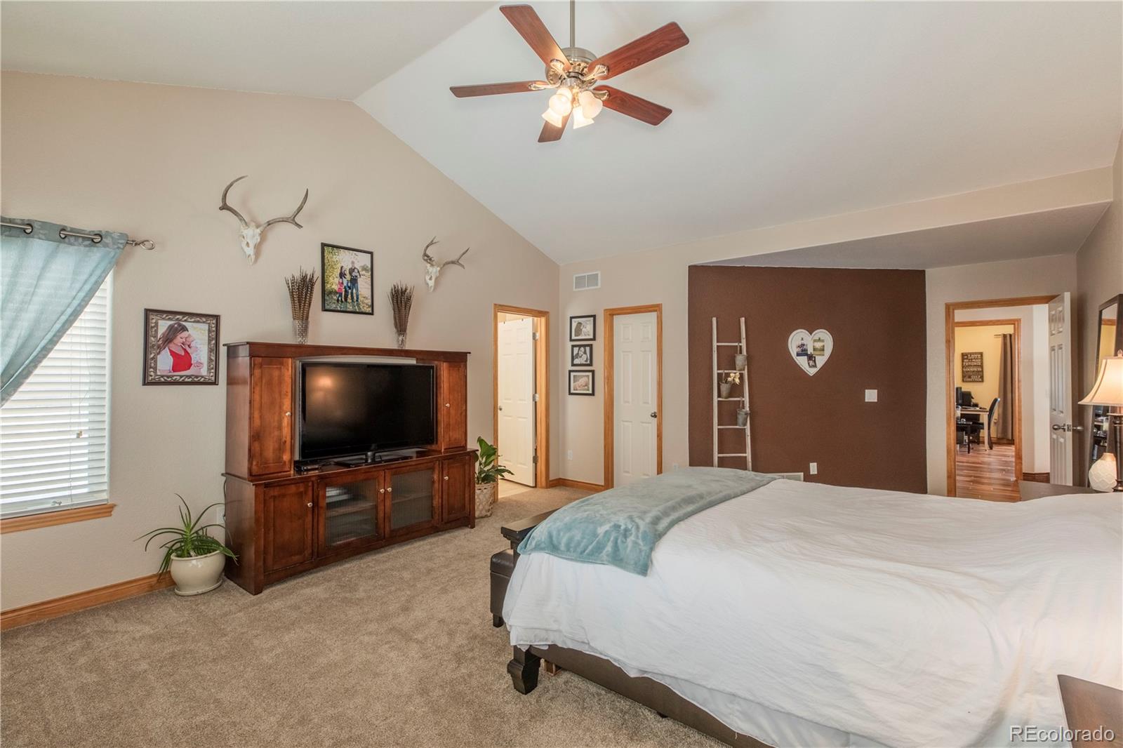 16504 Badminton Road North Platteville, CO 80651 - Photo 14 of 39 a bedroom with a bed and a flat screen tv