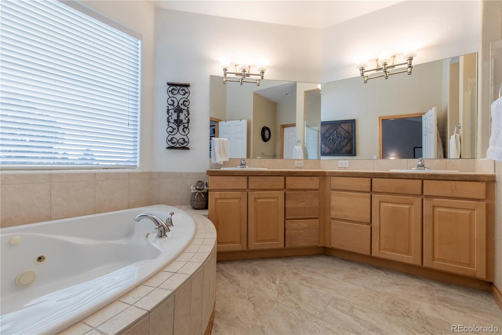 16504 Badminton Road North Platteville, CO 80651 - Photo 15 of 39 a spacious bathroom with a tub sink and mirror