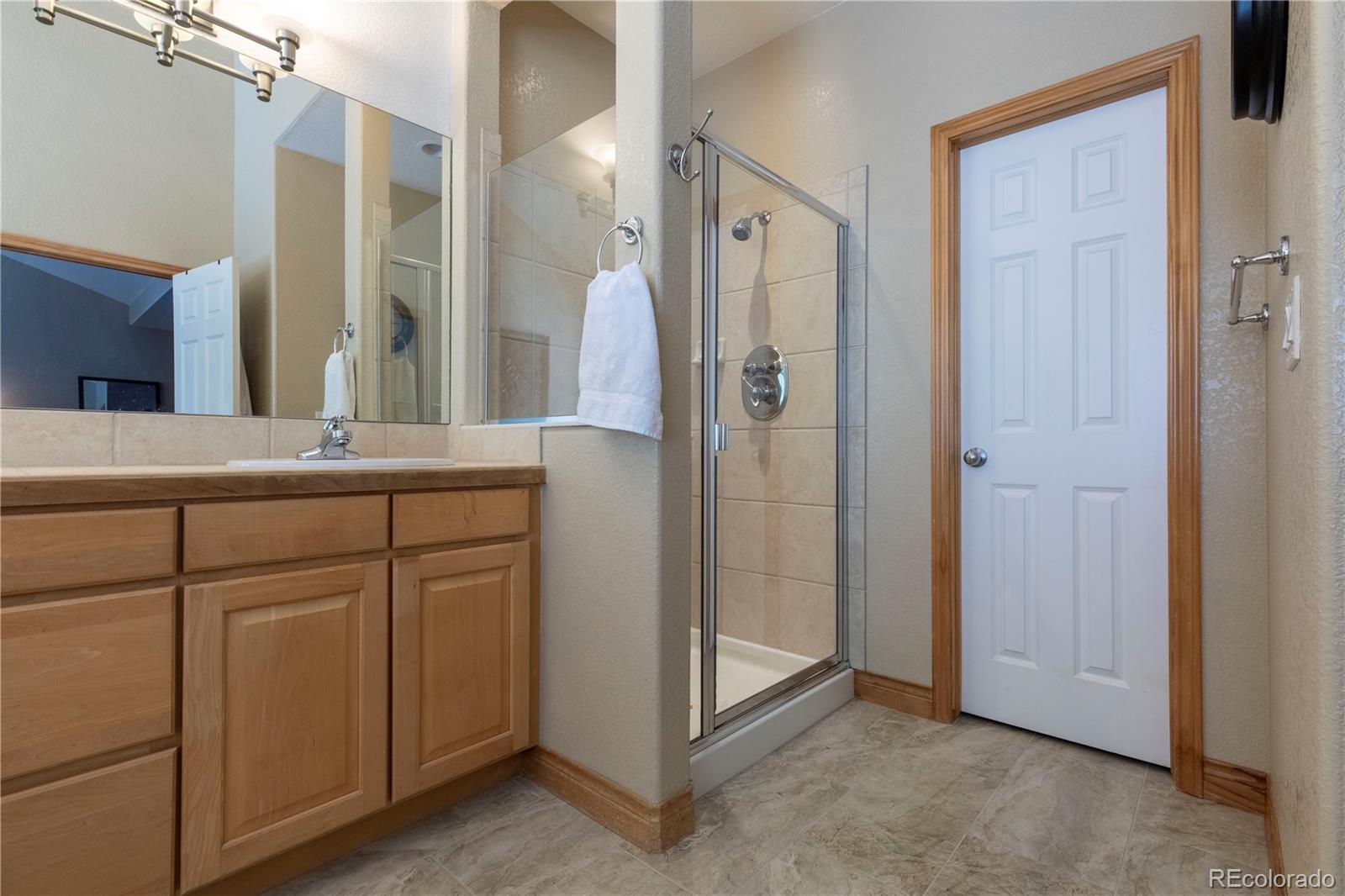 16504 Badminton Road North Platteville, CO 80651 - Photo 16 of 39 a bathroom with a shower and a sink