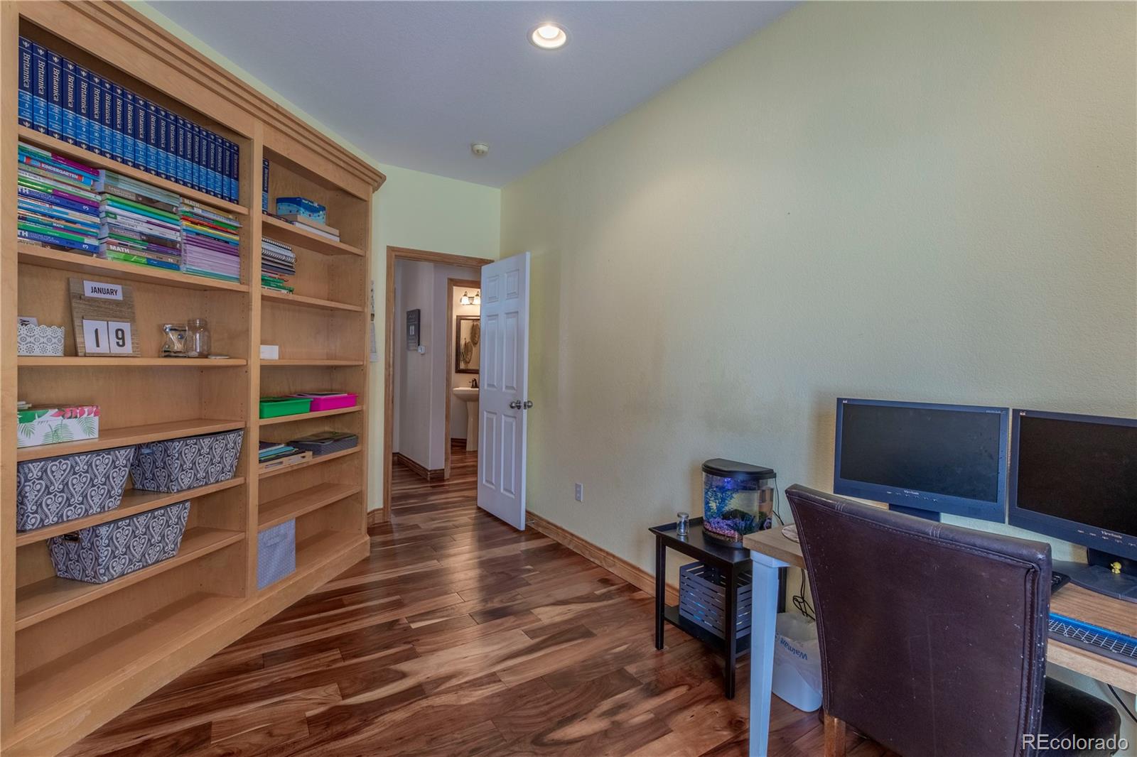 16504 Badminton Road North Platteville, CO 80651 - Photo 19 of 39 a room with furniture and wooden floor