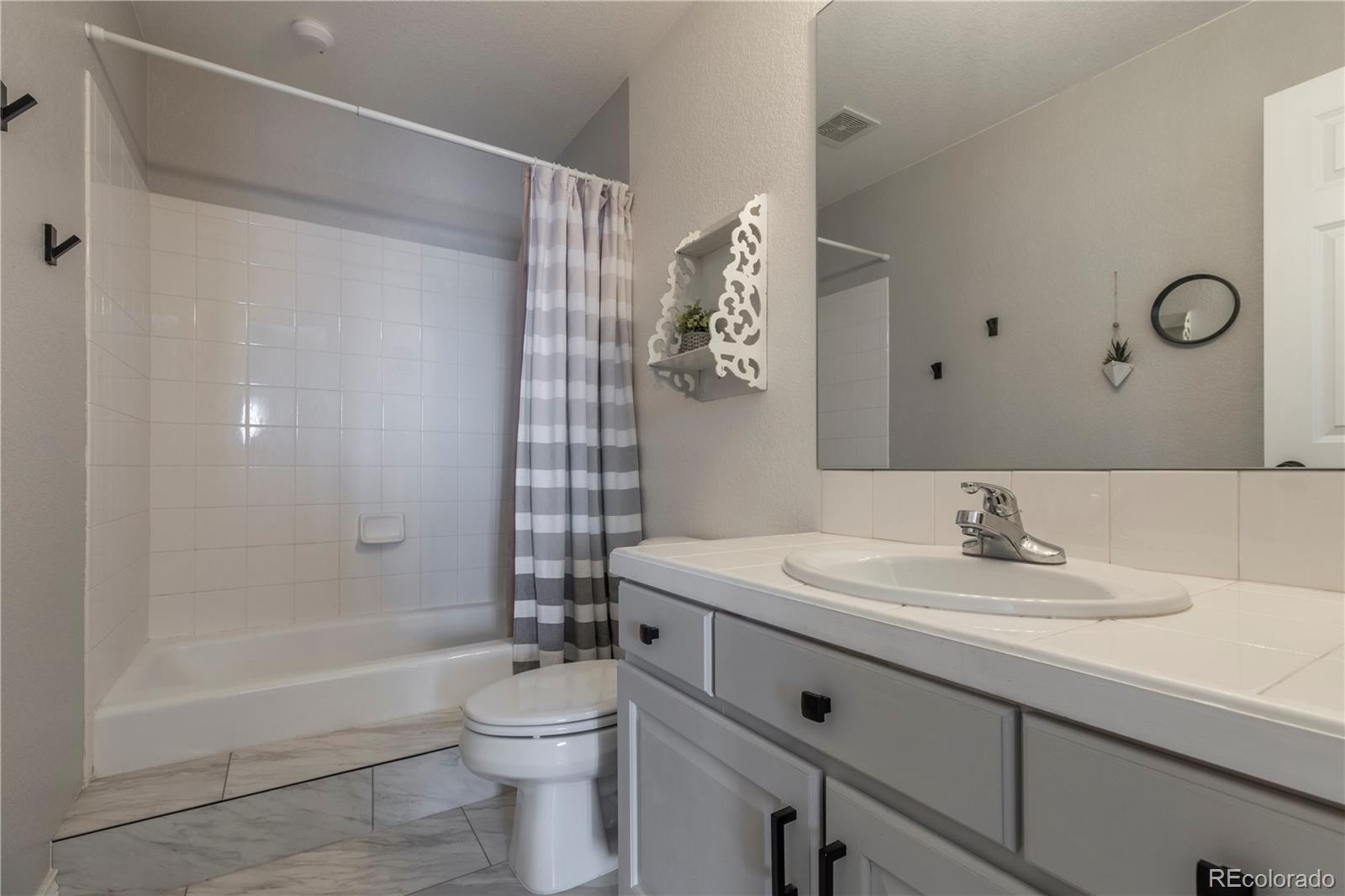 16504 Badminton Road North Platteville, CO 80651 - Photo 24 of 39 a bathroom with a sink a toilet and shower
