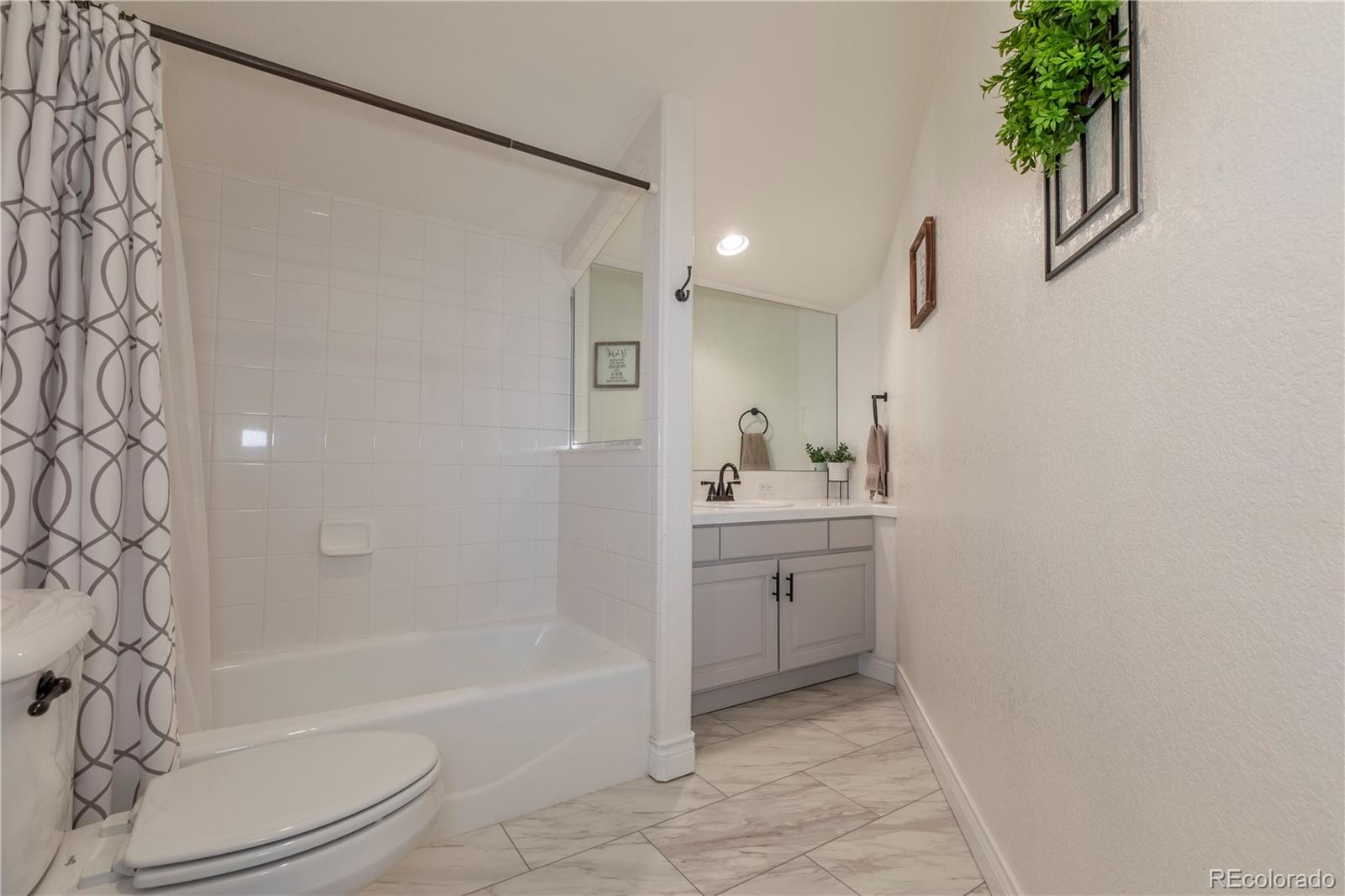 16504 Badminton Road North Platteville, CO 80651 - Photo 25 of 39 a bathroom with a granite countertop sink a toilet and shower