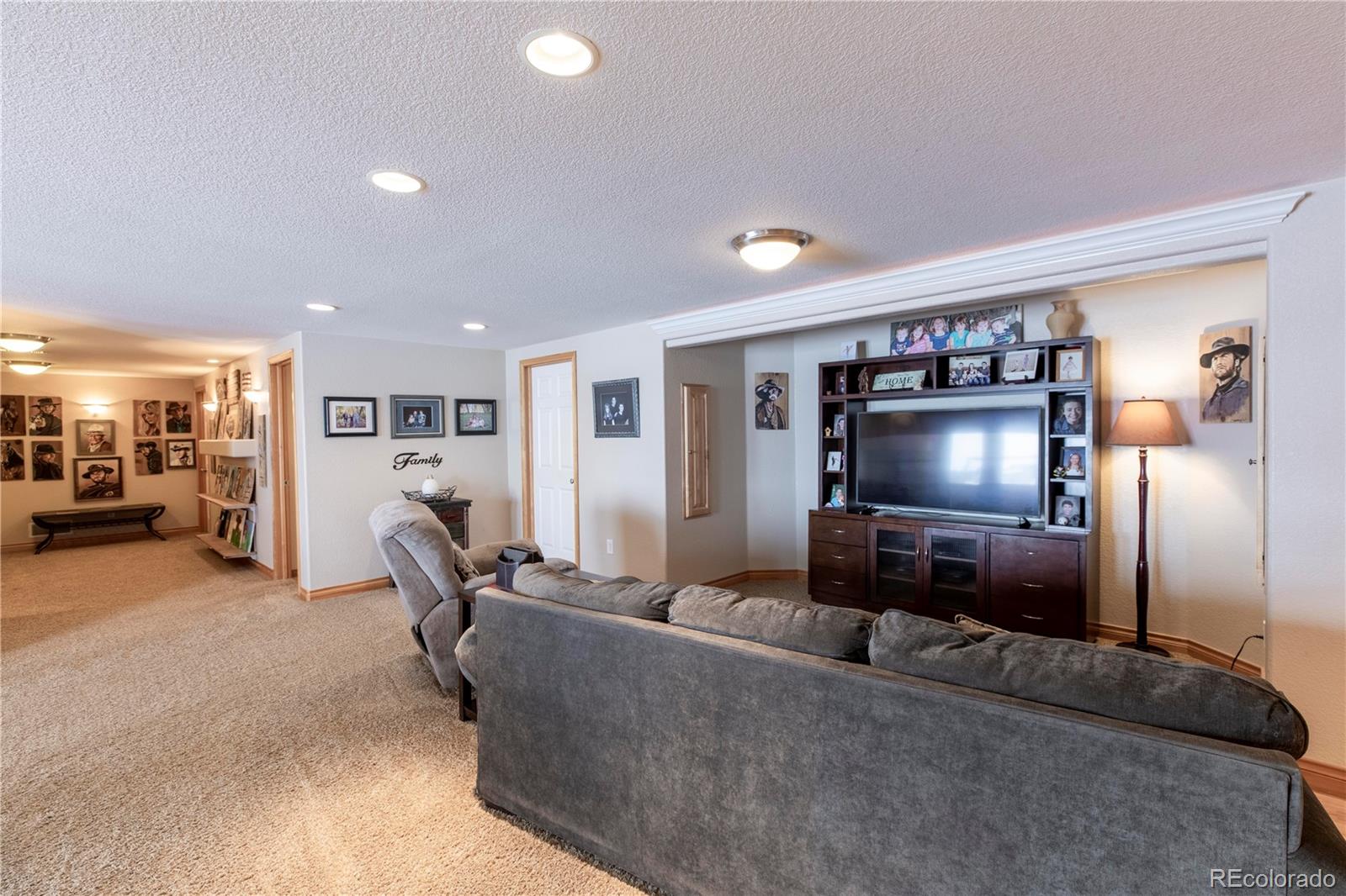 16504 Badminton Road North Platteville, CO 80651 - Photo 28 of 39 a living room with furniture and a flat screen tv