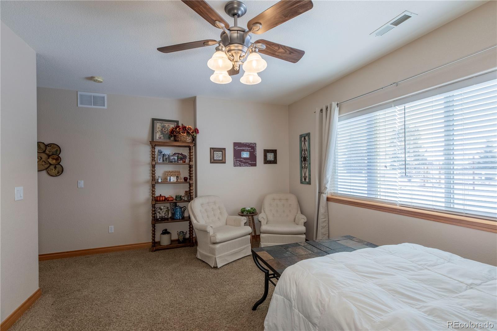 16504 Badminton Road North Platteville, CO 80651 - Photo 32 of 39 a bedroom with a bed a chandelier and a window