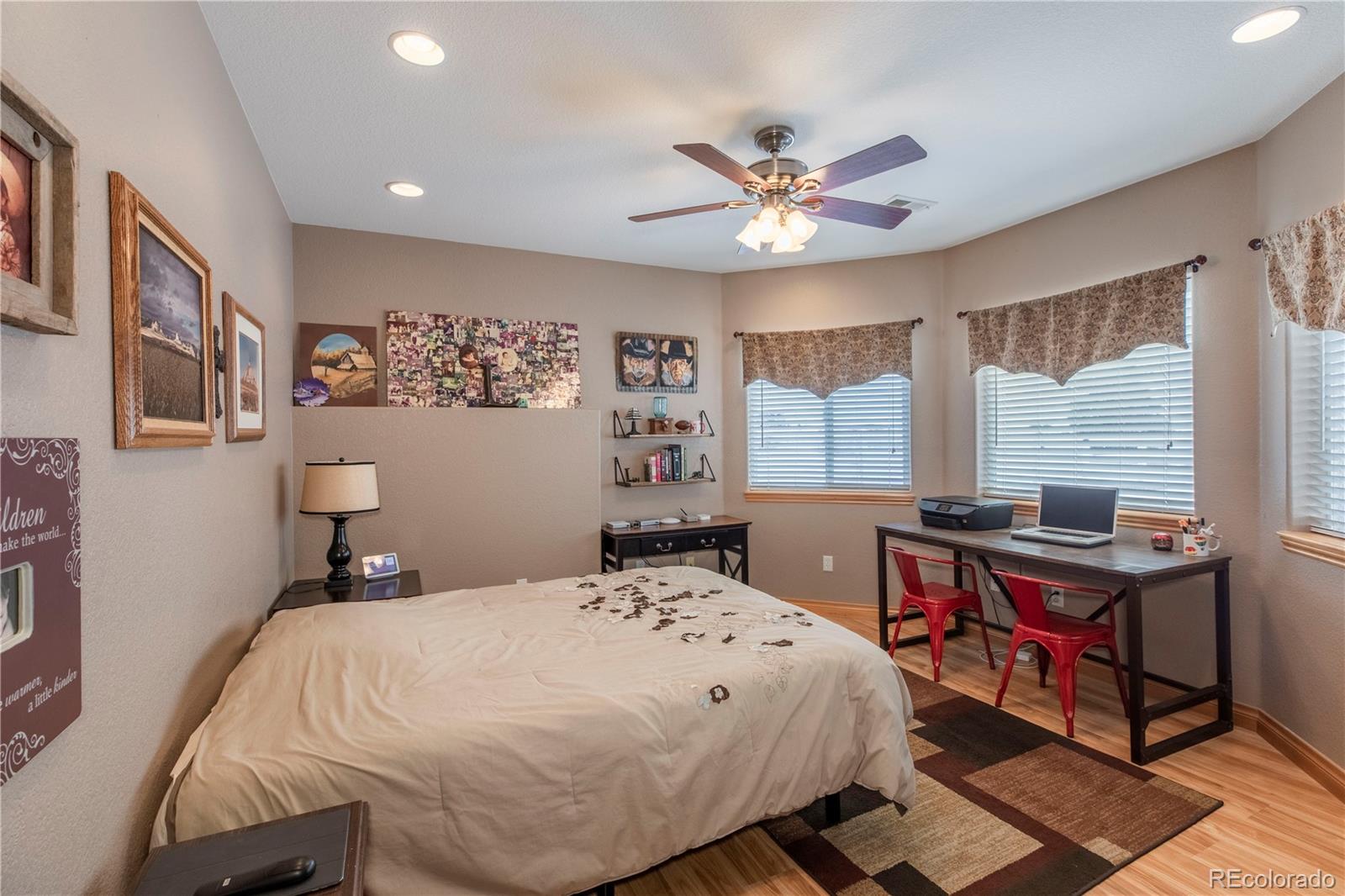 16504 Badminton Road North Platteville, CO 80651 - Photo 33 of 39 a bedroom with a bed and a chandelier
