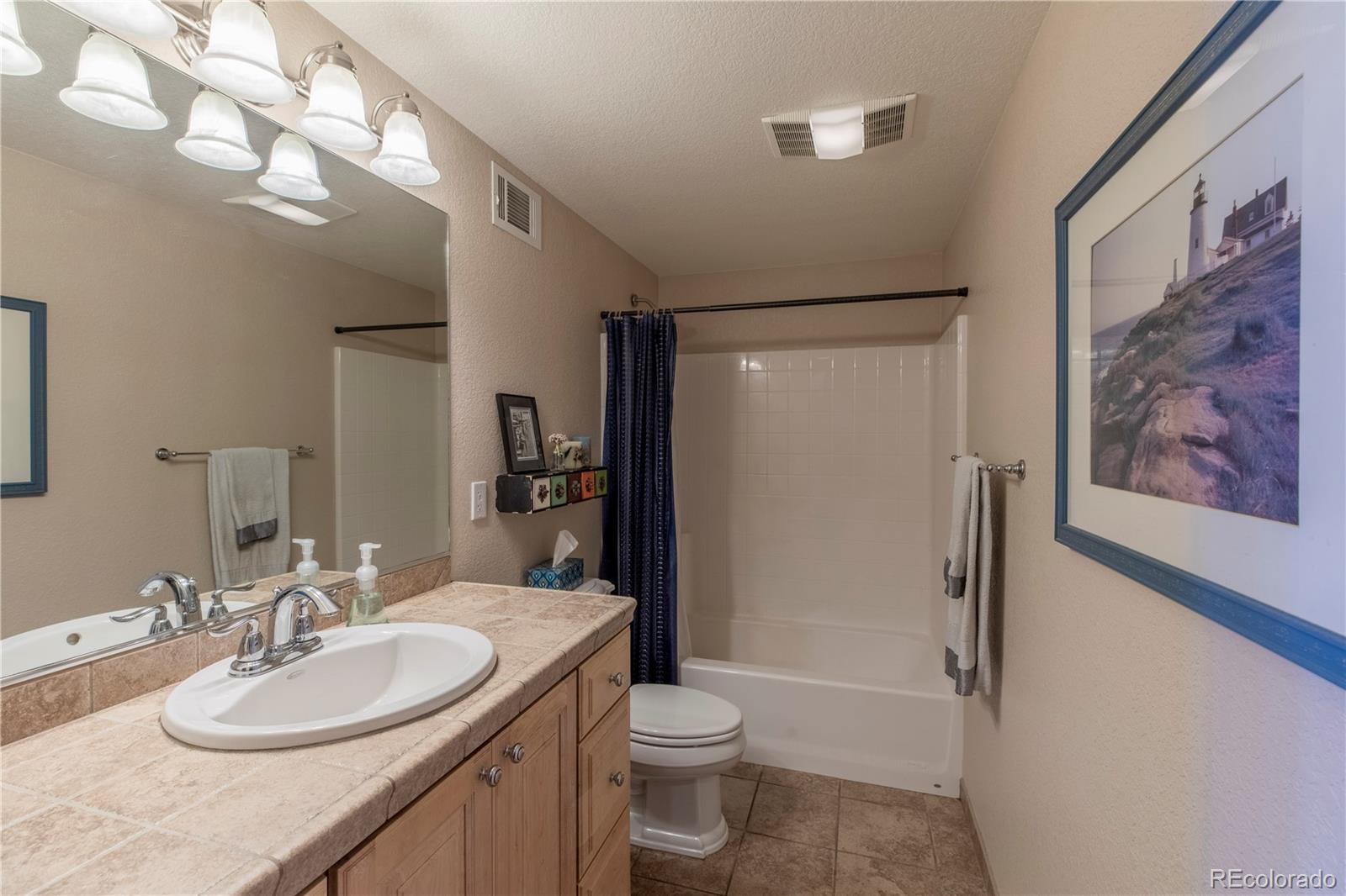16504 Badminton Road North Platteville, CO 80651 - Photo 34 of 39 a bathroom with a granite countertop sink toilet and shower