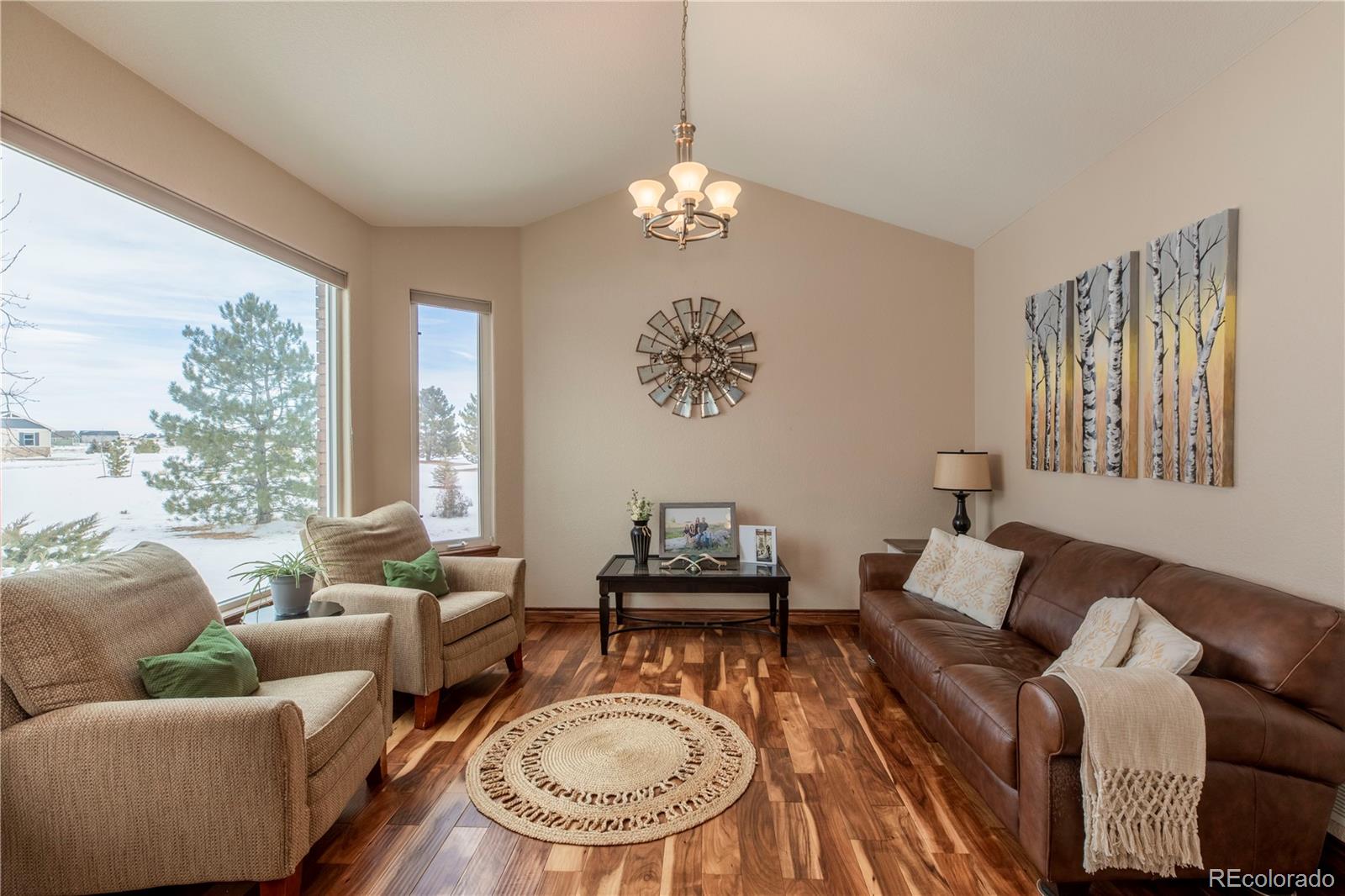 16504 Badminton Road North Platteville, CO 80651 - Photo 6 of 39 a living room with furniture and a chandelier