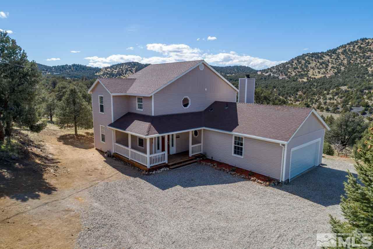 1900 Castle Peak Road Reno, NV 89521 - Photo 1 of 1 a view of a house with a big yard and large tree