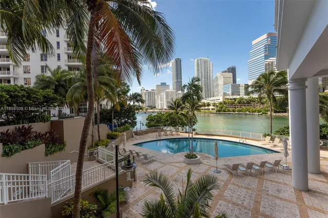 a swimming pool with outdoor seating and yard