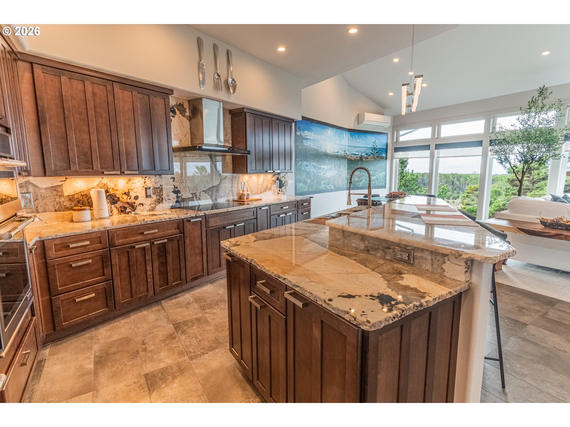 11 Fawn Ridge Lane Florence, OR 97439 - Photo 5 of 17 a kitchen with kitchen island granite countertop a table chairs sink and cabinets