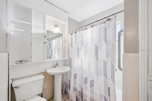 a bathroom with a sink a mirror and a shower