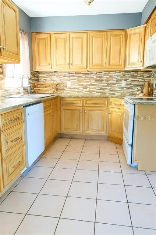 603 Oak Ridge Drive Brandon, FL 33510 - Photo 3 of 6 a kitchen with a white cabinets next to a window