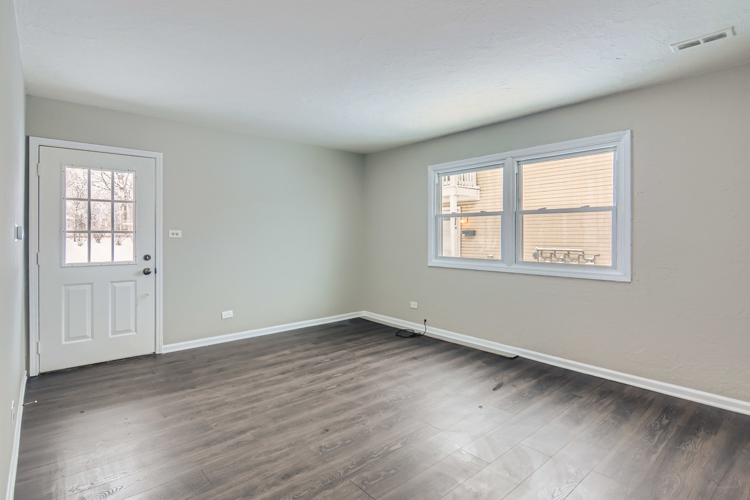 185 Rita Court, Unit A Bartlett, IL 60103 - Photo 2 of 11 an empty room with wooden floor and windows