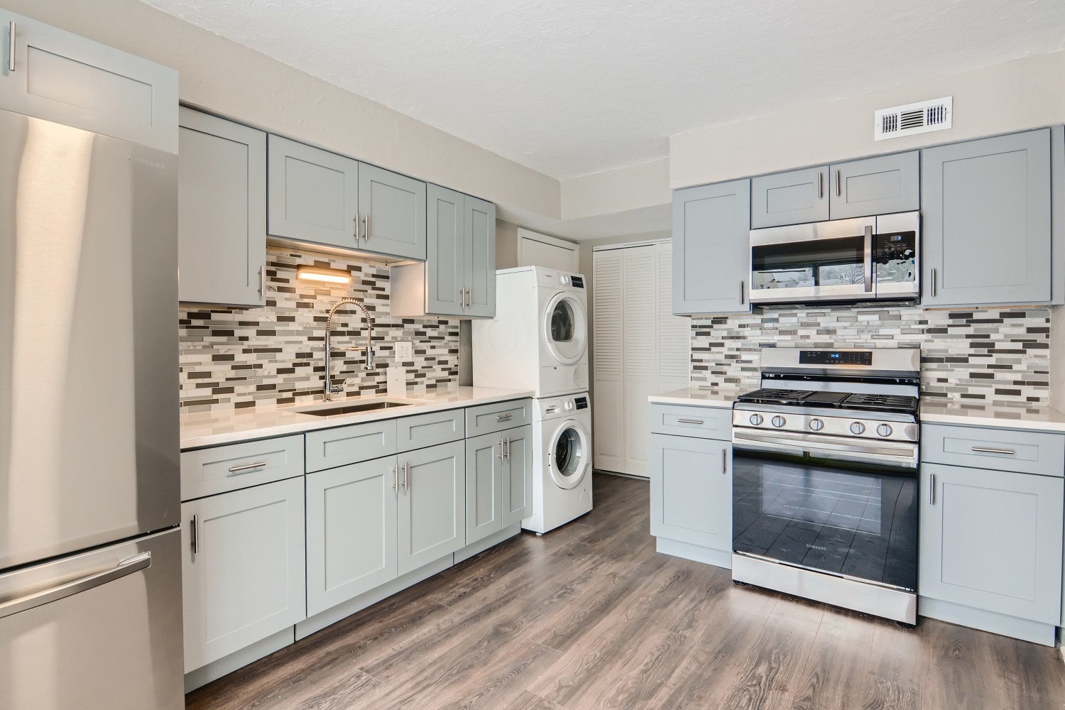 185 Rita Court, Unit A Bartlett, IL 60103 - Photo 4 of 11 a kitchen with stainless steel appliances white cabinets and a stove top oven