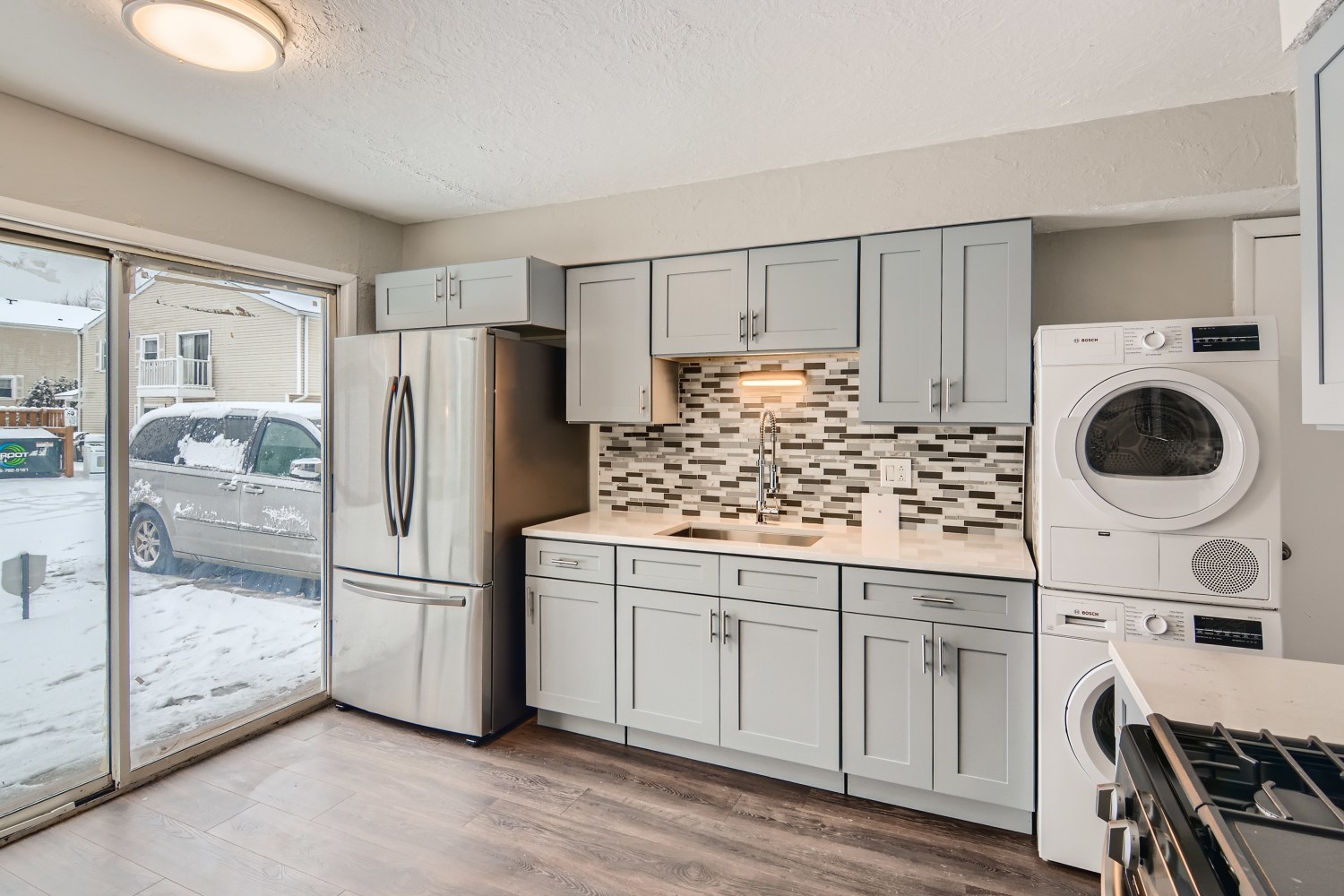 185 Rita Court, Unit A Bartlett, IL 60103 - Photo 5 of 11 a kitchen with a refrigerator and white cabinets