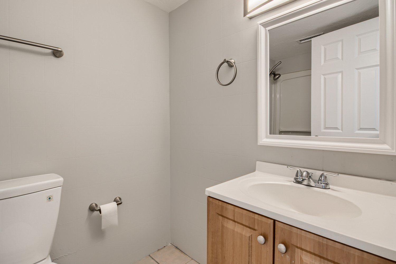 185 Rita Court, Unit A Bartlett, IL 60103 - Photo 8 of 11 a bathroom with a granite countertop sink a toilet and a mirror