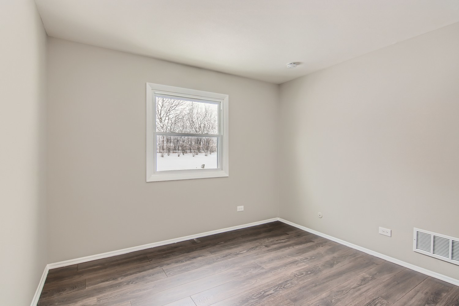 185 Rita Court, Unit A Bartlett, IL 60103 - Photo 9 of 11 an empty room with wooden floor and windows