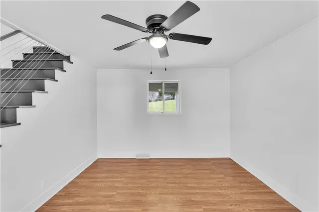wooden floor in an empty room with a window