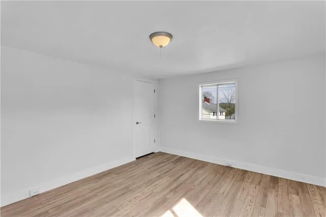 a view of a room with wooden floor and window