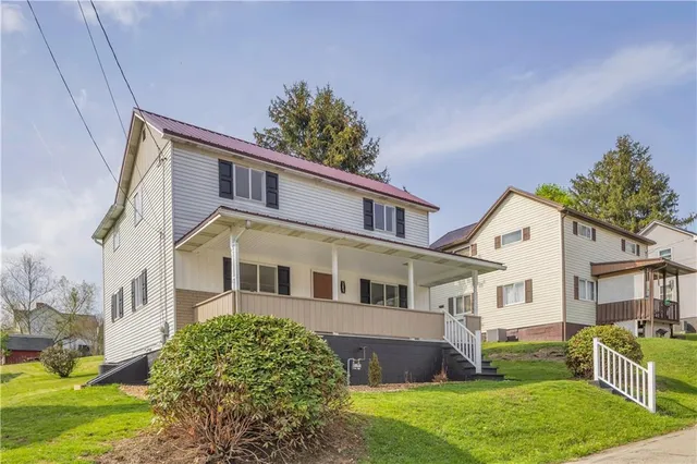 a front view of a house with a yard