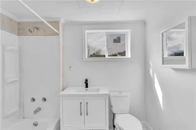 a white toilet sitting next to a bathroom sink