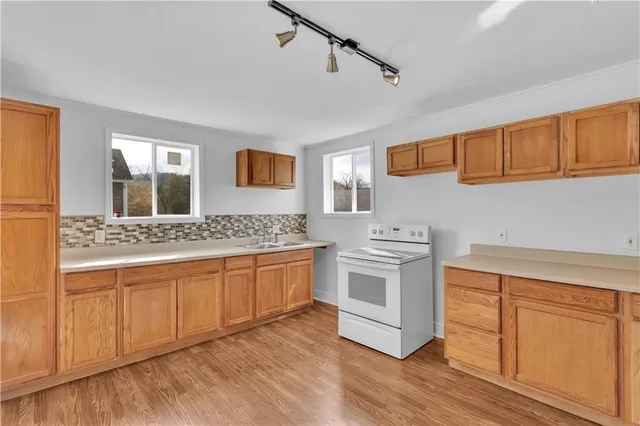 a kitchen with stainless steel appliances granite countertop a sink and cabinets