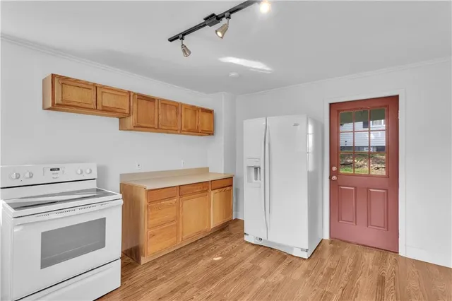 a view of a kitchen with wooden floor