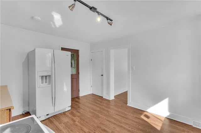 a view of an empty room and wooden floor