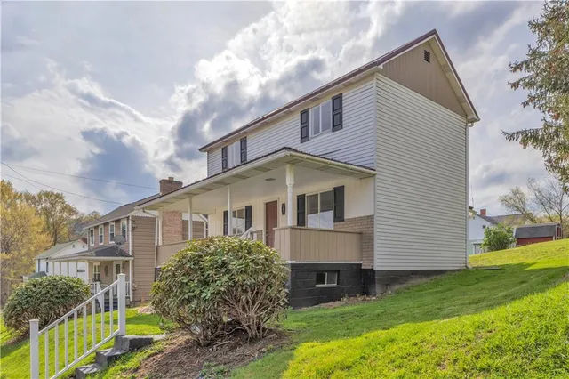 a front view of a house with garden