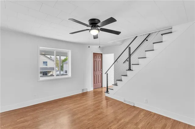 a view of entryway and hall with wooden floor